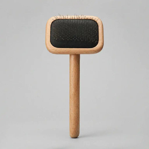 Wooden brush with black bristle head on a gray background