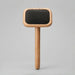 Wooden brush with black bristle head on a gray background