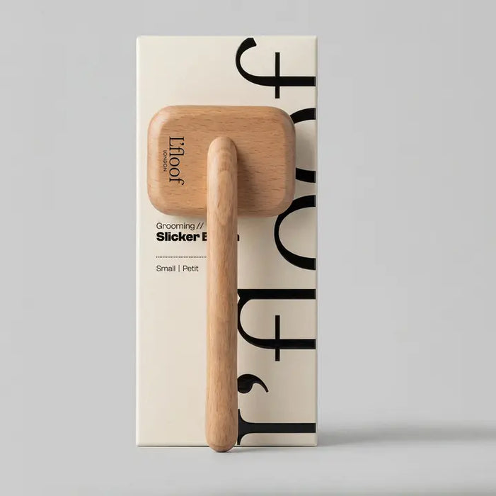 Wooden grooming tool with 'l'foof' packaging on a gray background