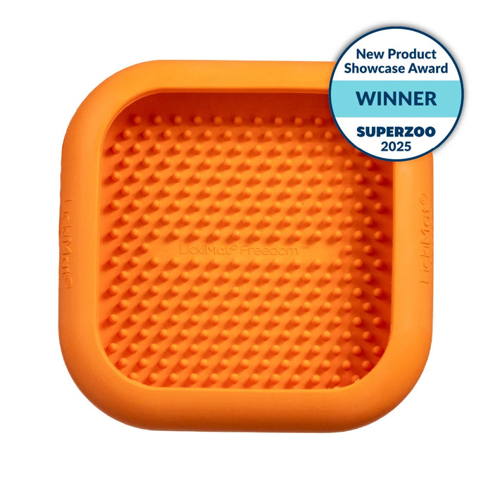 Orange silicone mat with textured surface on a white background, featuring a SuperZoo 2025 award badge.