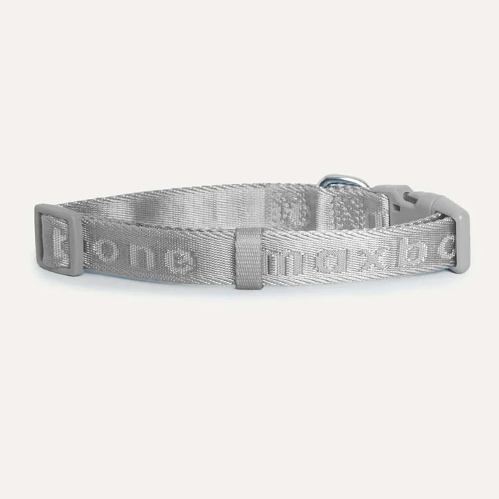 Grey dog collar with brand name on a white background