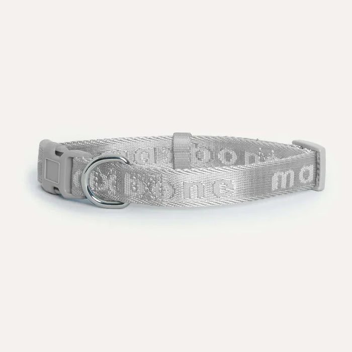 Grey dog collar with a pattern on a white background