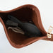 A brown zippered cosmetic pouch shown open, revealing a dark gray hairbrush and a white hair tie inside. The pouch has a gold-tone zipper pull and the brand name 'LOOMEE' printed inside.