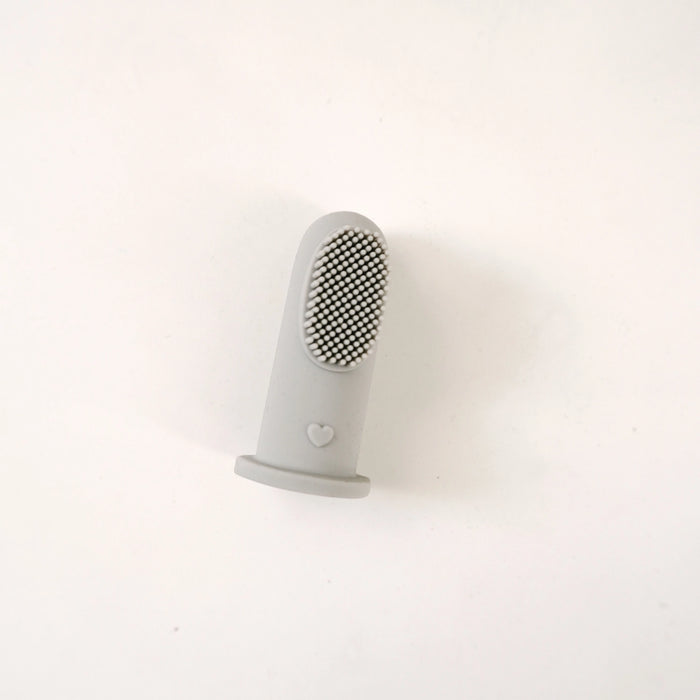 grey silicone finger toothbrush on a white background