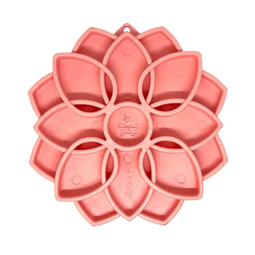 Pink silicone mold shaped like a flower on a white background