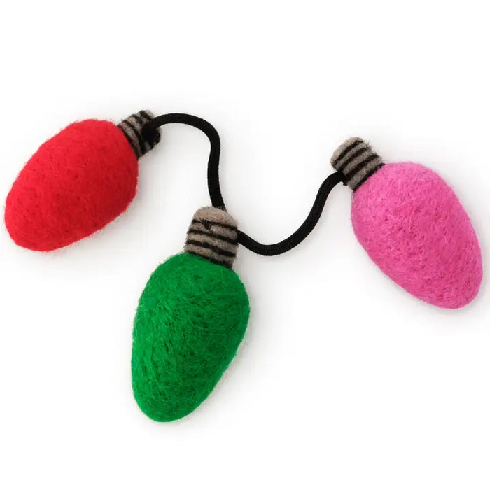 Three colorful light bulb-shaped hair ties on a white background