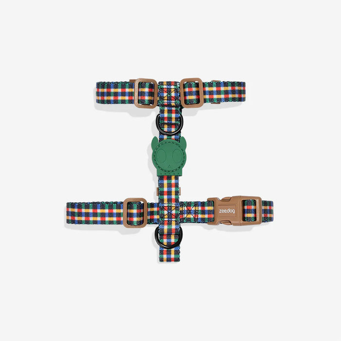 Colorful plaid dog harness with a green handle on a white background