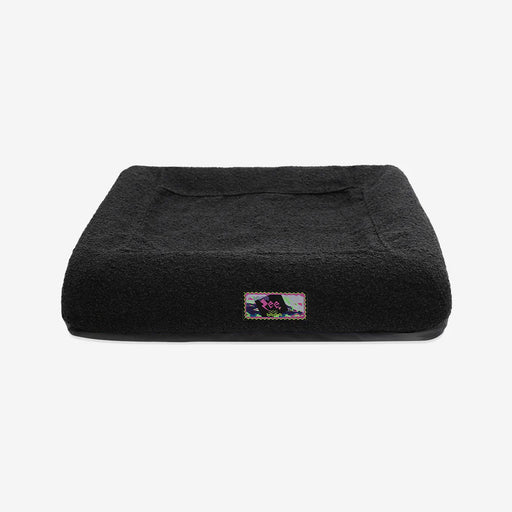 Black pet bed with a brand logo on a white background