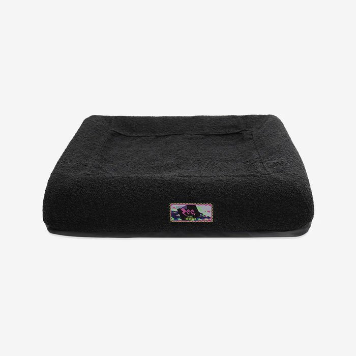 Black pet bed with a brand logo on a white background