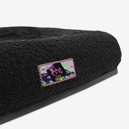 Black pet bed with a colourful 'Zee' logo on a white background