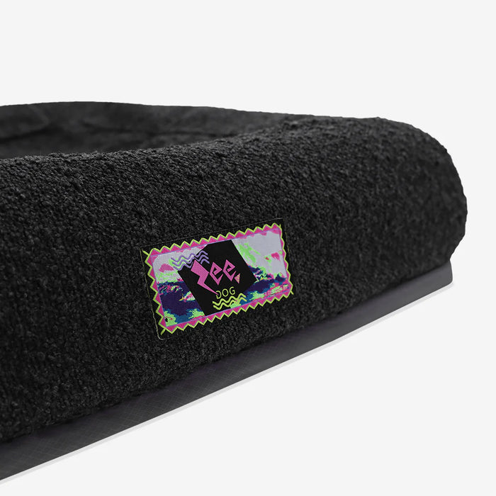 Black pet bed with a colourful 'Zee' logo on a white background
