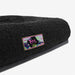 Black pet bed with a colourful 'Zee' logo on a white background
