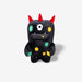 Black plush toy with colorful spots and red horns on a white background