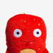 Red plush toy with a face on a white background