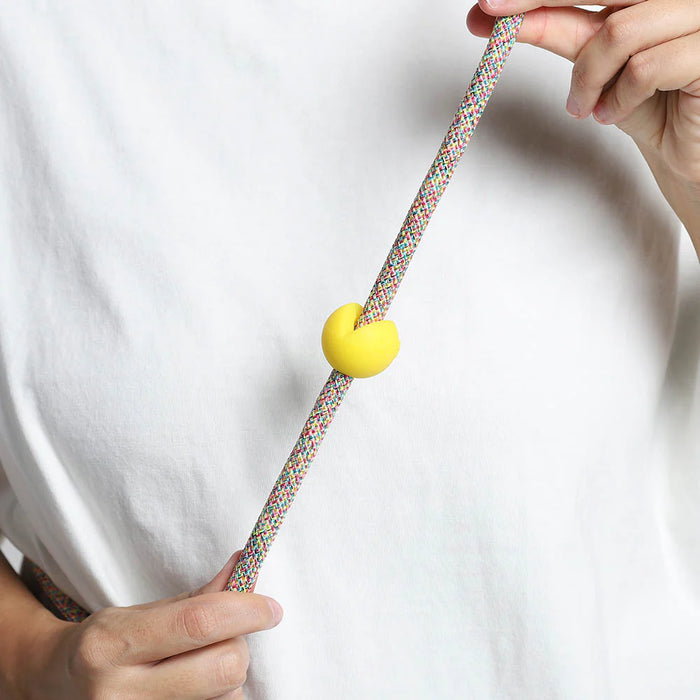 Yellow rubber pinz with hands on a rope lead and white t shirt