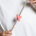 abstract rubber pinz with hands on a rope lead and white t shirt