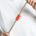 red gummy bear rubber pinz with hands on a rope lead and white t shirt