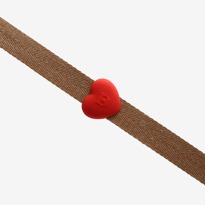 Red heart-shaped object with a logo on a brown belt against a white background