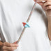saturn rubber pinz with hands on a rope lead and white t shirt