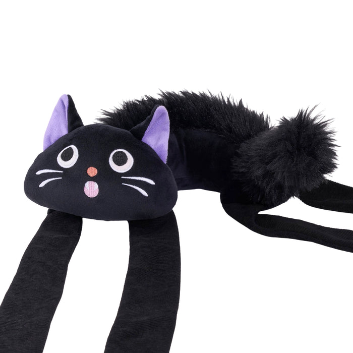 A black cat-shaped plush headband with long black straps, a fluffy tail, purple inner ears, and embroidered facial features on a white background.