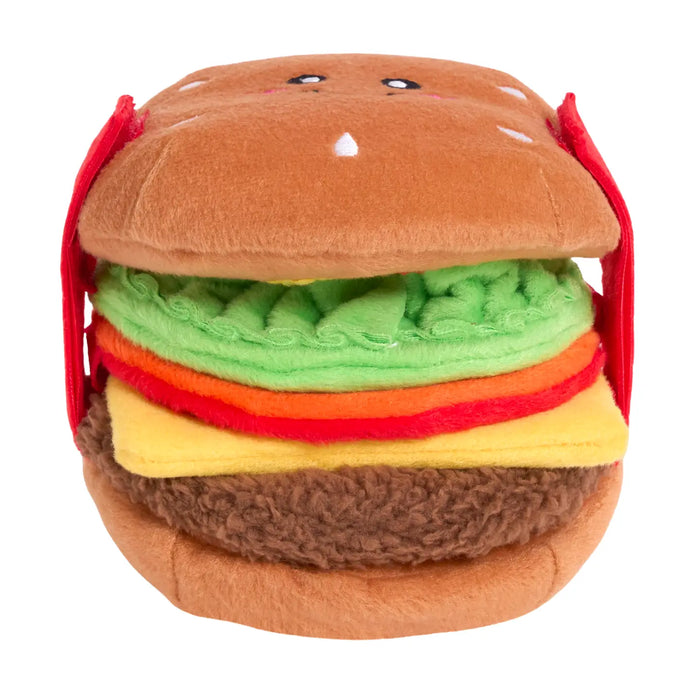 Plush toy shaped like a hamburger with layers of brown, green, red, and yellow on a white background.