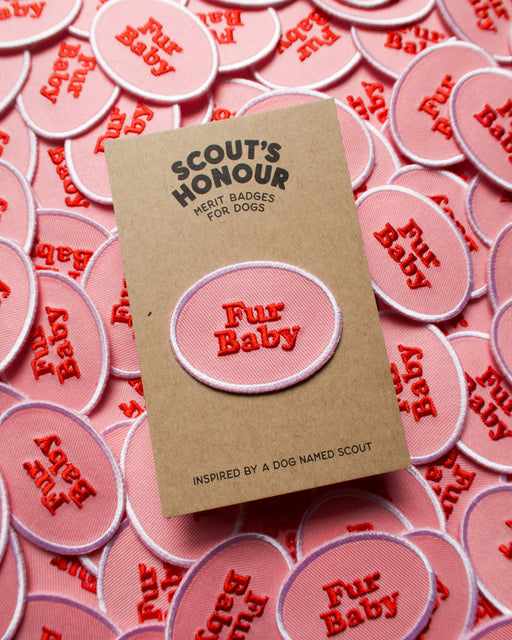Scouts Honour Fur Baby iron-on badges in Pink and red complemented by a white round border.