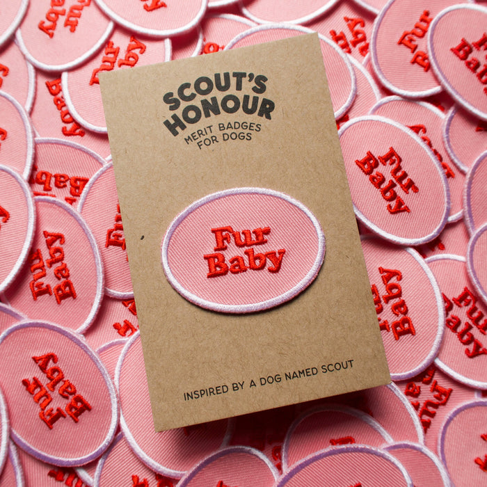 Scouts Honour Fur Baby iron-on badges in Pink and red complemented by a white round border.