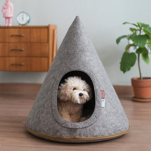 Small Pet Cave by Nooee Pet in Grey, with a brown lined zipper. Inside the pet cave there is a small dog.