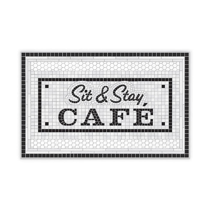 Placemat with small black and white tile motif reading "sit and stay cafe" is pictured on a white background