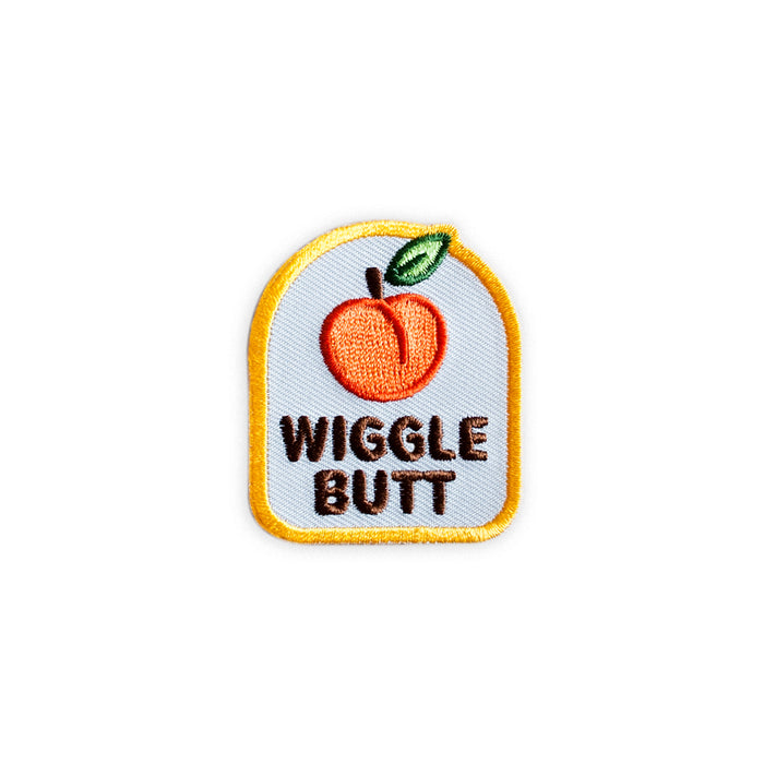 Scouts Honour "Wiggle But" iron-on badge with orange peach icon