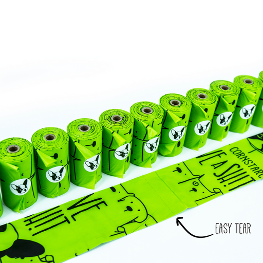 A row of Give a Shit cornstarch based green coloured dog poop bags is displayed on a white backdrop